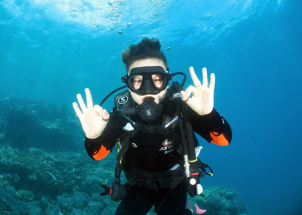 Teen scuba diving at Moore Reef on the Great Barrier Reef with Sunlover Reef Cruises