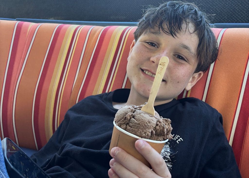 Teenager eating ice cream at the Cairns Marina after a day on the Great Barrier Reef with Sunlover