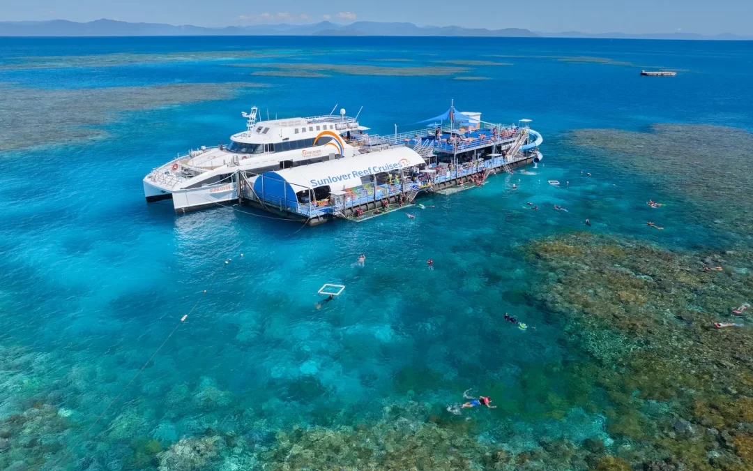 Aerial view of Sunlover Reef Cruises pontoon at Moore Reef on the Great Barrier Reef, with snorkellers exploring the coral reef from Cairns